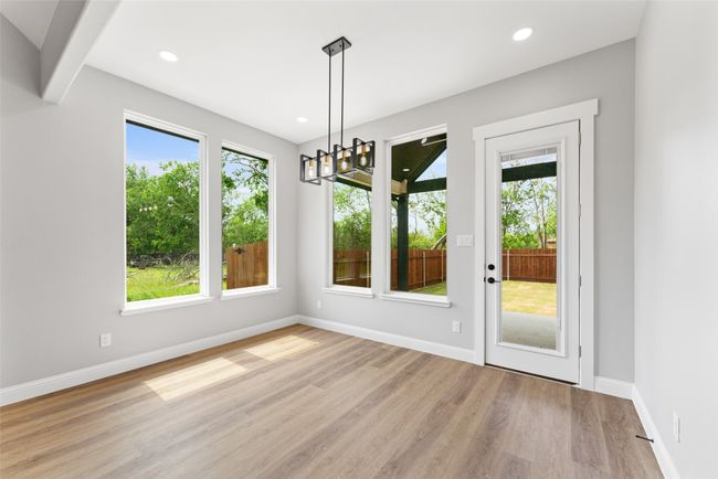 Unfurnished dining area featuring recessed lighting, baseboards, a notable chandelier, and light wood-style flooring | Image 23