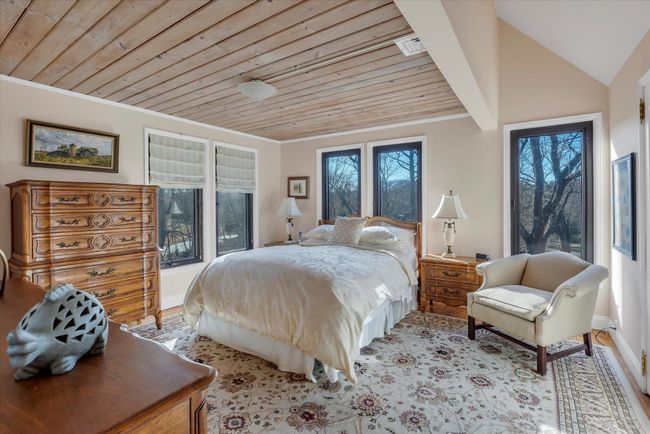 Bedroom with crown molding, wooden ceiling, and light wood-type flooring | Image 14