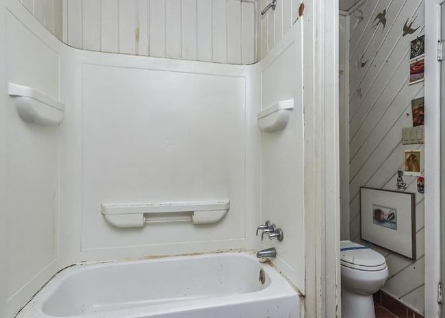 Bathroom with a bath and toilet | Image 18