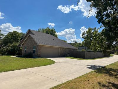 View of side of property featuring central AC, a yard, and a garage | Image 2