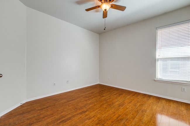 Spare room featuring hardwood / wood-style flooring, baseboards, and ceiling fan | Image 19