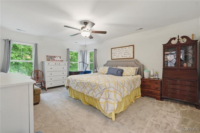 Comfortable upstairs bedroom with ceiling fan and generous closet space. | Image 29