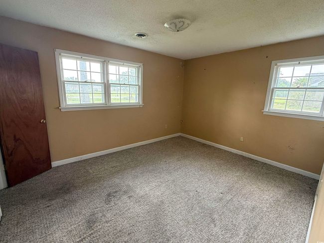 Carpeted spare room with plenty of natural light, a textured ceiling, and baseboards | Image 11