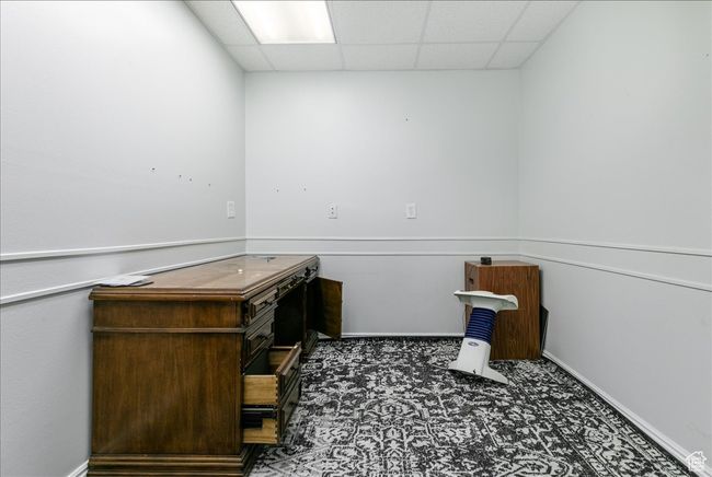 Unfurnished office with a paneled ceiling and baseboards | Image 19