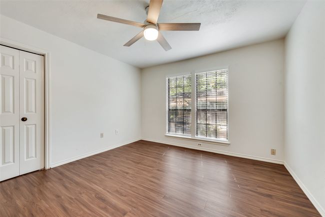 Unfurnished bedroom featuring wood finished floors and ceiling fan | Image 14