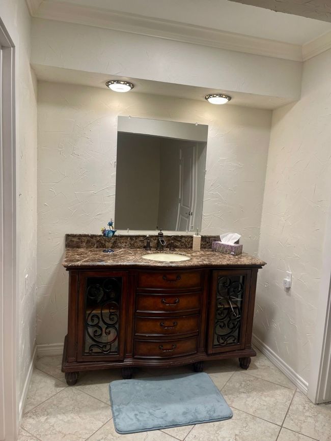 Bathroom with vanity, crown molding, tile patterned floors, and baseboards | Image 20