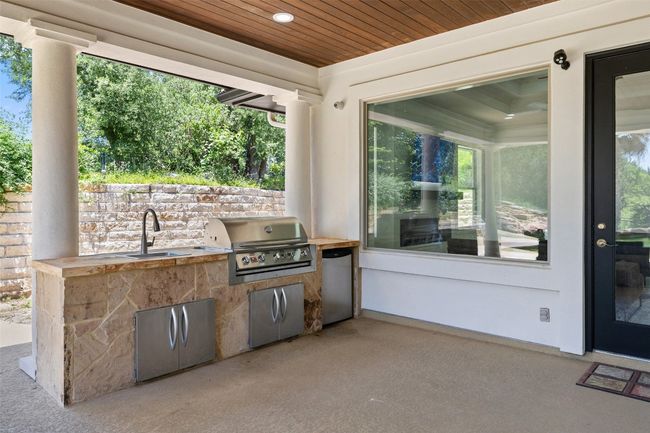 View of patio with a sink, a grill, and exterior kitchen | Image 35