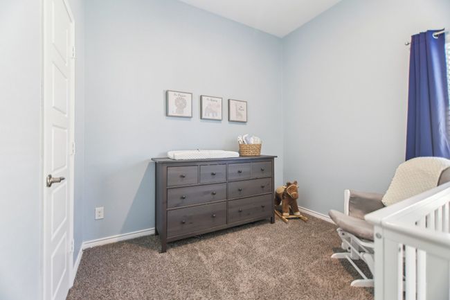 Bedroom featuring a crib, carpet, and baseboards | Image 25