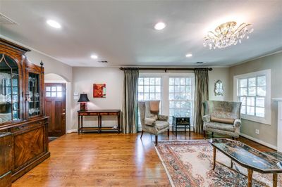 Sitting room with ornamental molding, an inviting chandelier, and light wood-type flooring | Image 3