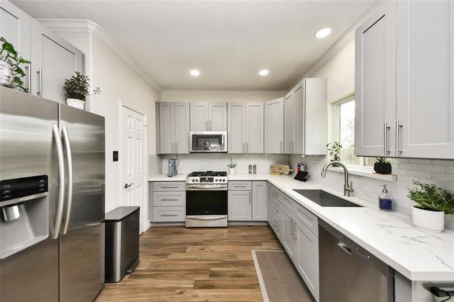 Step into a beautifully designed, modern kitchen perfect for cooking and entertaining. | Image 13