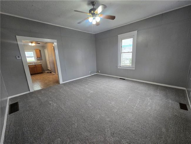 Unfurnished room with a ceiling fan, carpet flooring, and baseboards | Image 25