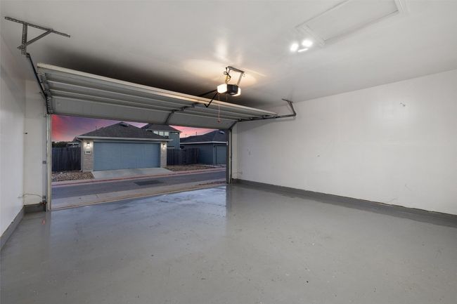 Garage featuring baseboards and a garage door opener | Image 27