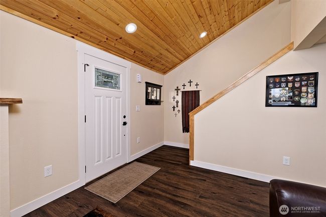Main entry and stairway to loft bedroom with view and half bath. | Image 21