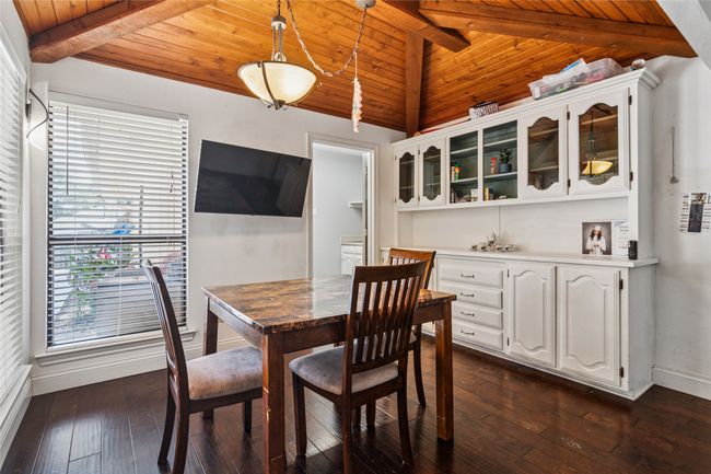 Dining room with wooden ceiling and dark wood-style floors | Image 8