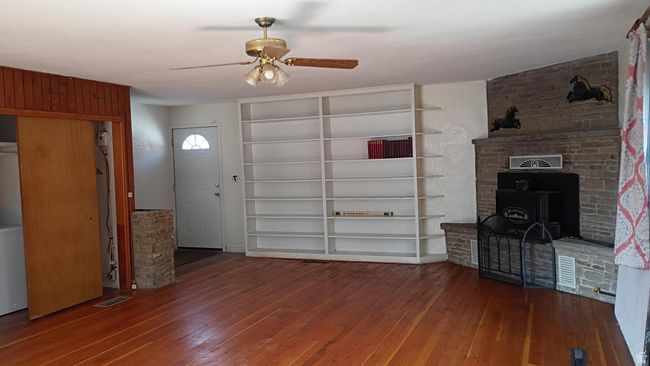 Family room featuring hardwood / wood-style flooring, bookcase and a ceiling fan | Image 38
