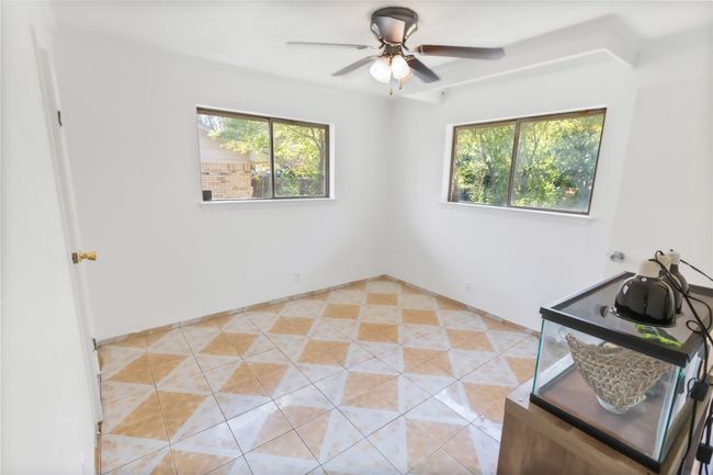 Tiled spare room with ceiling fan | Image 11