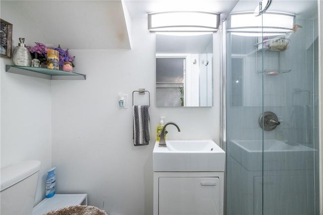 lower level Bathroom featuring vanity, toilet, and a shower | Image 18