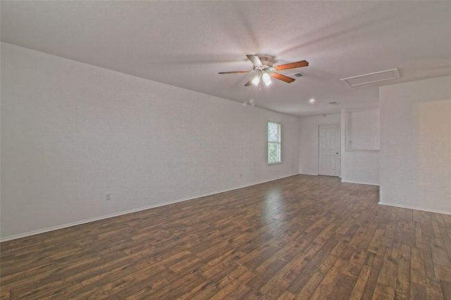 Spare room with dark wood finished floors and a ceiling fan | Image 22