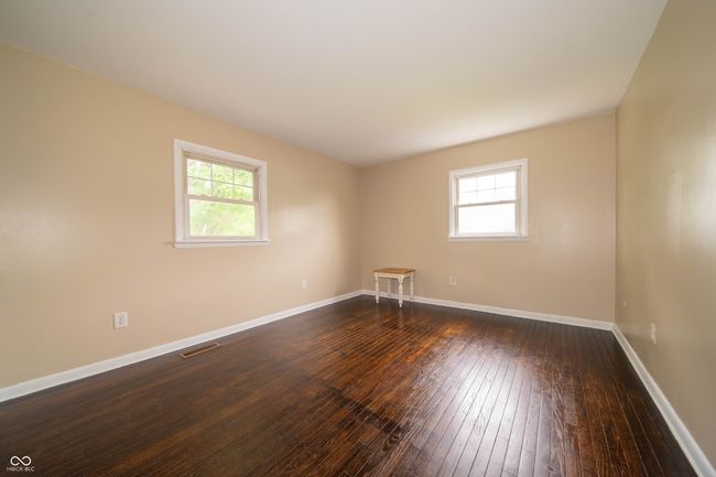 spare room with healthy amount of natural light, dark wood-style floors, and baseboards | Image 35