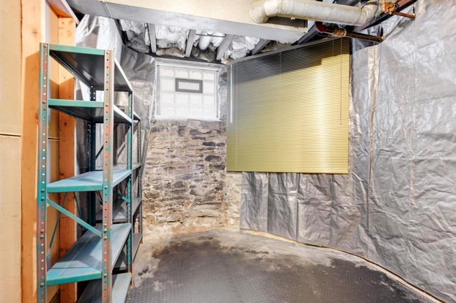 Unit #1 has a large storage space with a vented glass block window for light and air movement. | Image 22