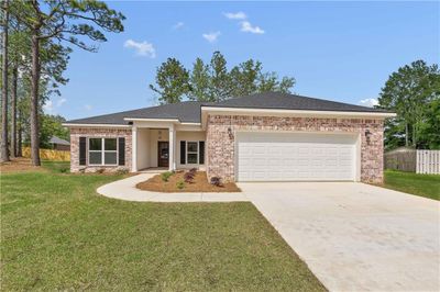 View of front of property featuring a garage and a front yard | Image 1