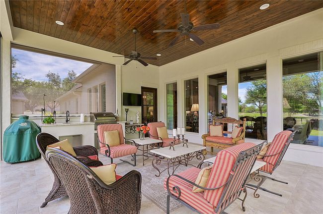 View of patio with area for grilling, an outdoor living space, and a ceiling fan | Image 21