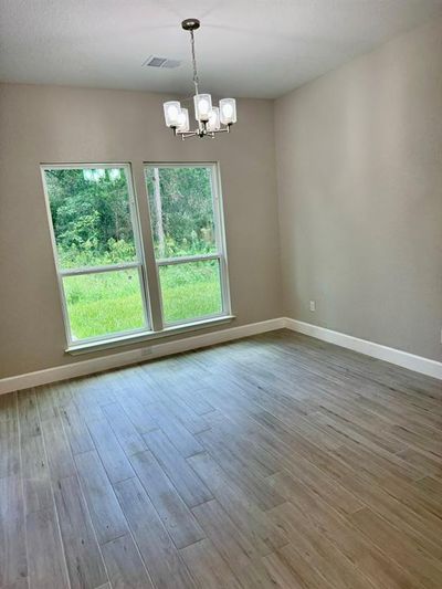 Breakfast room overlooks peaceful backyard | Image 3