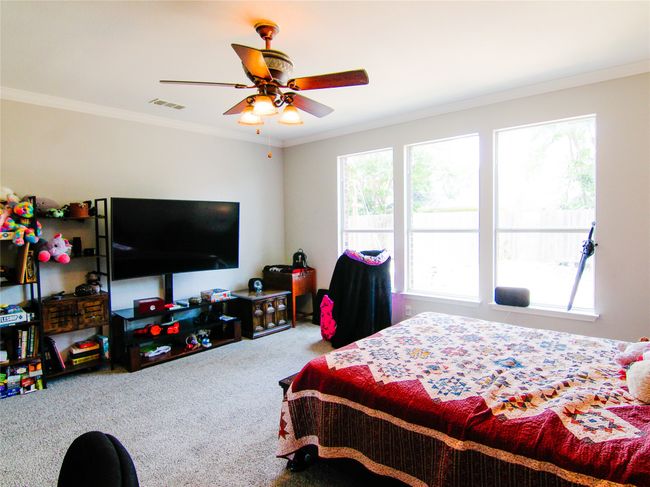 Carpeted bedroom with ornamental molding and ceiling fan | Image 10