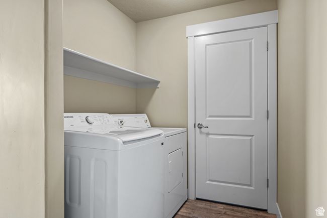 Laundry room with laundry area, dark wood-style flooring, and washer and clothes dryer | Image 22