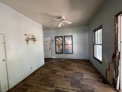 Unfurnished room with ceiling fan and dark hardwood / wood-style flooring | Image 2