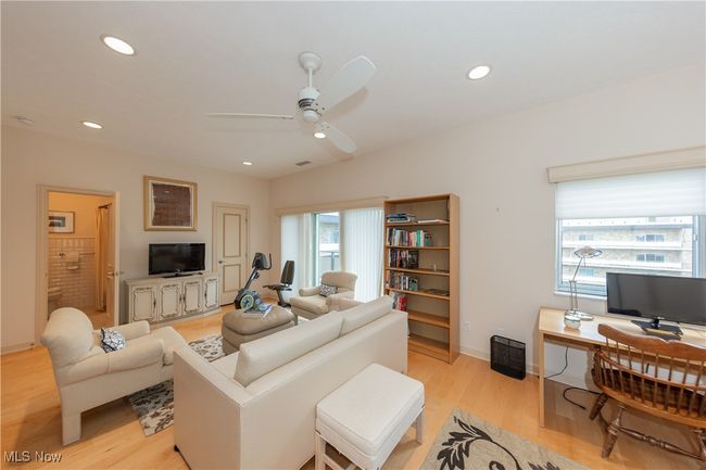 Guest Bedroom 1 sitting area featuring recessed lighting, light wood-style floors, baseboards, visible vents, and a ceiling fan | Image 40