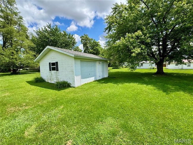 View of green lawn with an outbuilding and a detached garage | Image 35