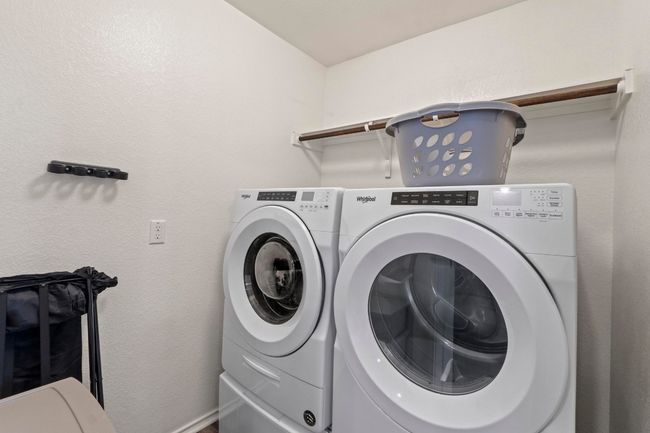 The separate laundry room has plenty of space for additional storage. | Image 13