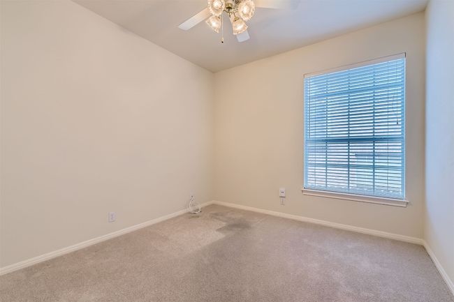 Secondary bedroom with ceiling fan, facing the side of the house | Image 24