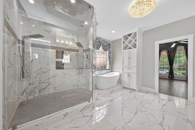Your private spa, oversized walk in shower features a very large rain shower head, and two separate jetted panels. | Image 23