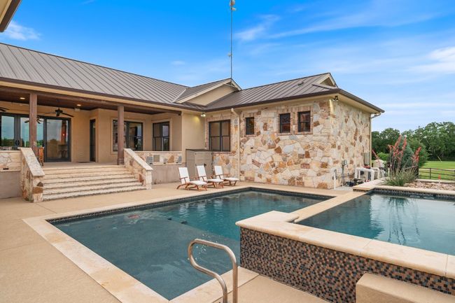 Pool with sundeck and hot tub/swim spa. | Image 25