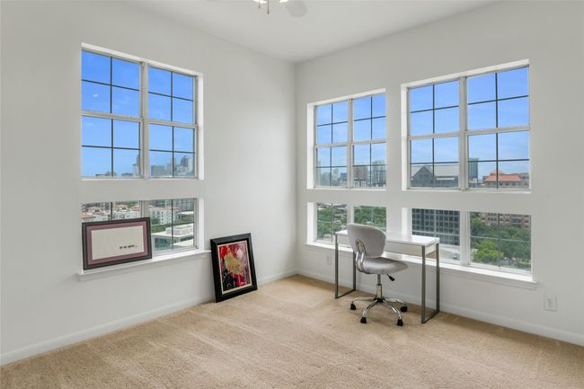 Home office featuring carpet flooring, a view of city, and ceiling fan | Image 19