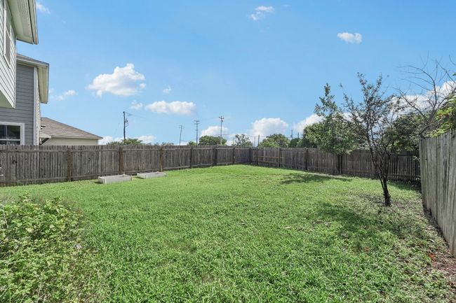 View of fenced backyard | Image 23