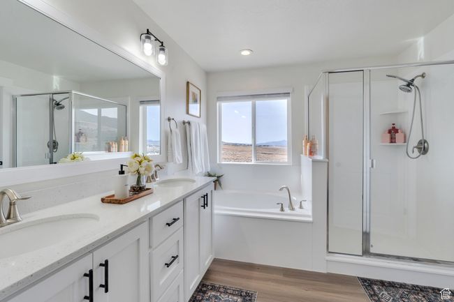 Bathroom with a shower stall, a bath, a sink, and wood finished floors | Image 18