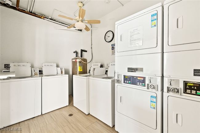Community laundry featuring estacked washer and dryer, washer and clothes dryer, a ceiling fan, and water heater | Image 23