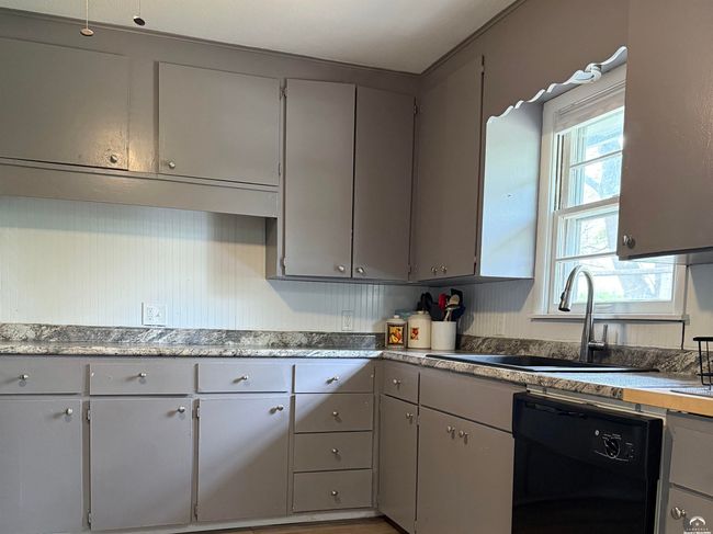 Large sized cooking space, plentiful cabinets and drawers, newer fan. Newer counters & wood block. | Image 4