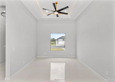 Unfurnished room with ceiling fan, a raised ceiling, and ornamental molding | Image 3