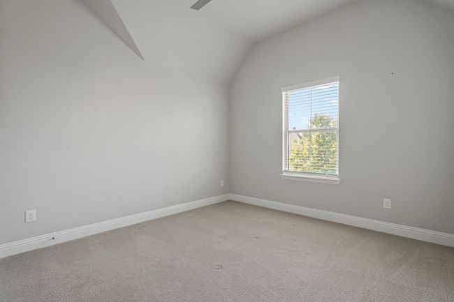 Spare room with light carpet, baseboards, and lofted ceiling | Image 23