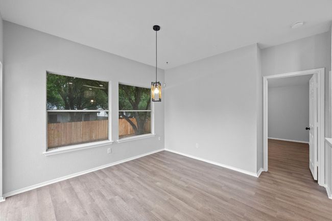dining area featuring new flooring, paint, and baseboards | Image 9