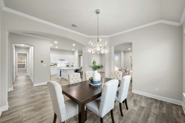 The elegant formal dining room features a stunning chandelier that adds a touch of sophistication to every meal. | Image 5