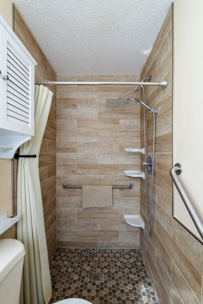 Accessible bathroom with custom tile and safety rails. No steps to get out of this shower! | Image 24