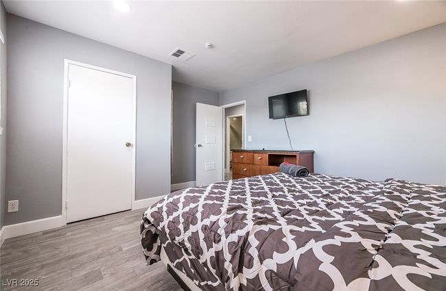 Bedroom with light wood finished floors, baseboards, and recessed lighting | Image 40