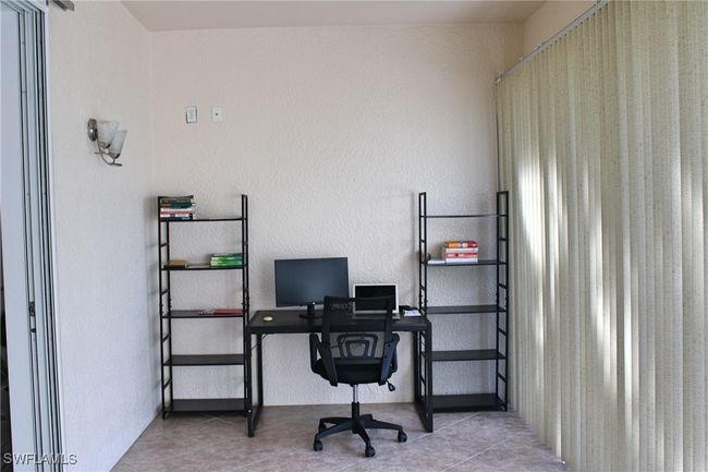 Office space featuring a textured wall and tile patterned floors | Image 13