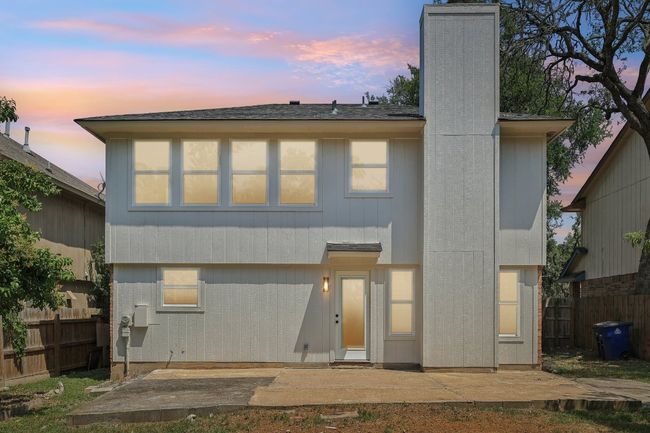 Back of house at dusk with a patio area and a chimney | Image 8