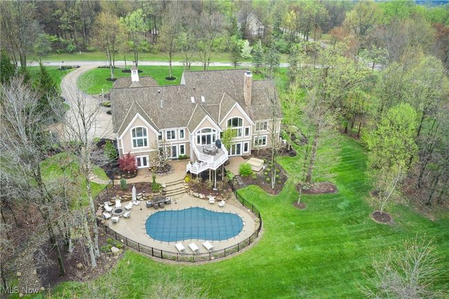 Surrounded by trees and a manicured lot. This home has trex deck, patio with fire pit and a newer 40x20 Salt water pool! | Image 49